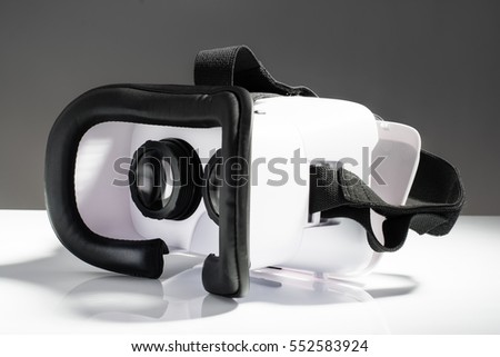 Virtual reality VR glasses or goggles isolated on white background with mirror reflection. Closeup product photograph. Computer simulated reality concept image with copy space