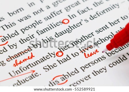 closeup red marks on proofreading english document Royalty-Free Stock Photo #552589921