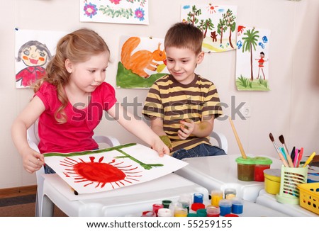 Children painting in play room. Child care.