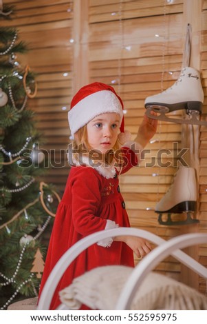 Little girl in santa costume with skates