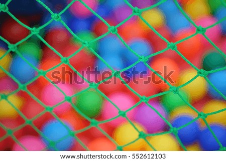Net or Rope and Colourful balls blur background in the kid's playground.