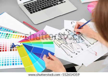 Young fashion designer working in office, closeup