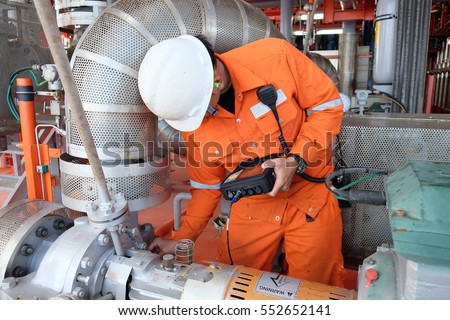 Mechanical engineer measurement of centrifugal pump vibration and electric motor at offshore oil and gas central processing platform, Oil and gas exploration and production in the gulf of Thailand. Royalty-Free Stock Photo #552652141