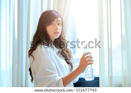 happy young woman drinking pure water on her bedroom. concept fo