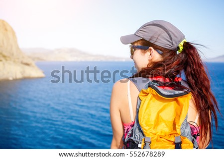 Brunette with backpack on mountain