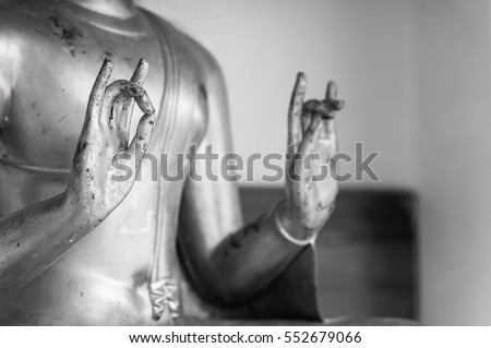 Close up Hand of Buddha statue in Thailand, Black and white picture of Buddha statue. buddhism concept, used as amulets of Buddhism religion