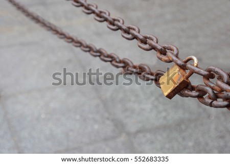 Color detail of some rusty chains and a lock, on background