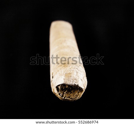cigar isolated on black background closeup