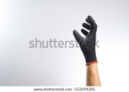 A hand wearing black glove with action gesture Royalty-Free Stock Photo #552694285
