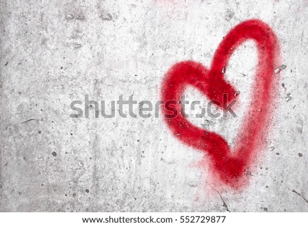 Red heart hand drawn on concrete wall