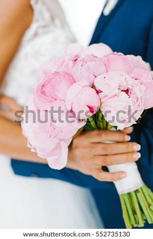 beautiful wedding bouquet of pink flowers in bride's hands