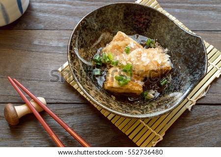 Agedashi tofu is crispy deep fried tofu served in flavorful tsuyu sauce and sprinkled with bonito flakes.