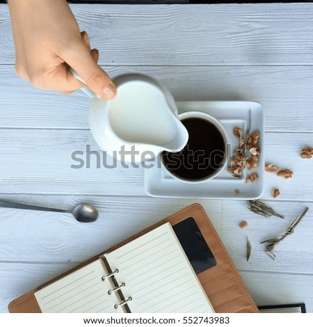 cup of coffee and cream on a wooden table