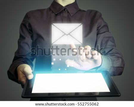 Image of a girl with tablet in her hands. She are sending email by using digital tablet. Online mail, correspondence, feedback, reporting