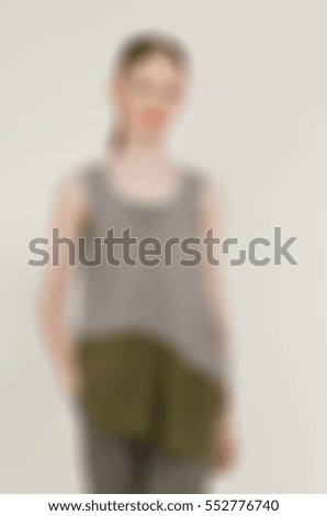Womens fashion clothing theme creative abstract blur background with bokeh effect. Young woman demonstrates designer clothing piece in studio environment for internet store