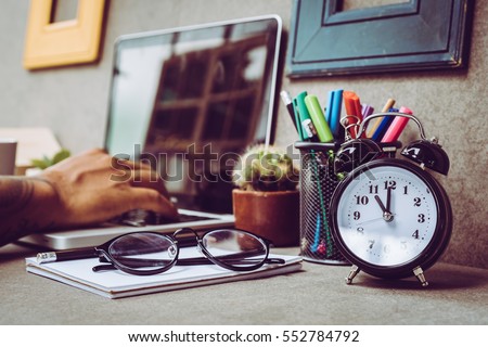 Man with tattoo working at home, save money for family  Royalty-Free Stock Photo #552784792
