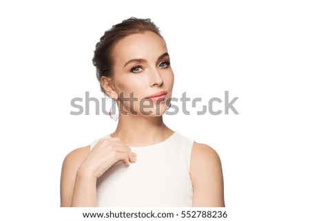 jewelry, luxury, wedding and people concept - smiling woman in white dress wearing pearl earrings over white background