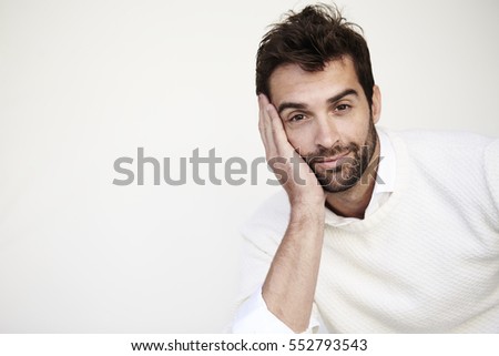 Guy in white sweater smiling at camera