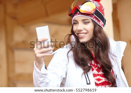 Young snowboard girl Speak Smart Phone