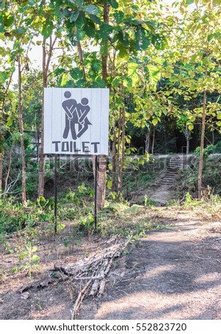 Restroom/Toilet signs with female and male symbol in the forest.