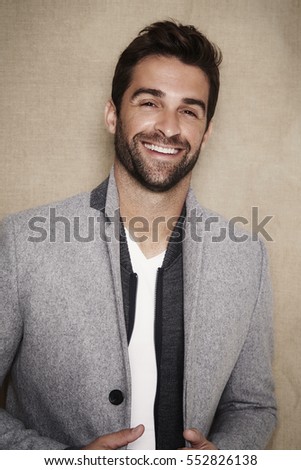 Smiling guy in grey coat, portrait