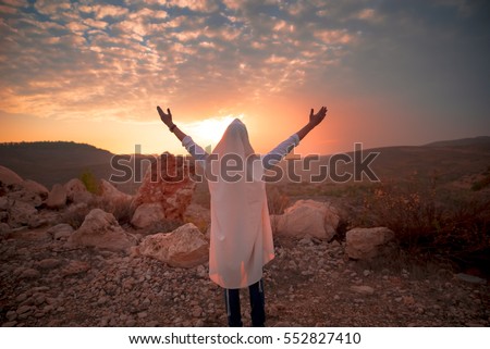 Jewish men prayer With Talit and tefillin in sunset Royalty-Free Stock Photo #552827410