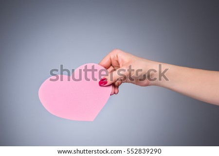 Heart shape love symbol in woman hand
