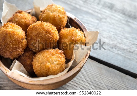 Bowl of arancini - rice balls with mozzarella Royalty-Free Stock Photo #552840022