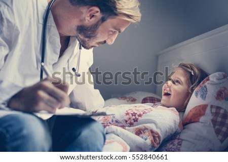 Young male doctor visiting his little patient in hospital. Royalty-Free Stock Photo #552840661