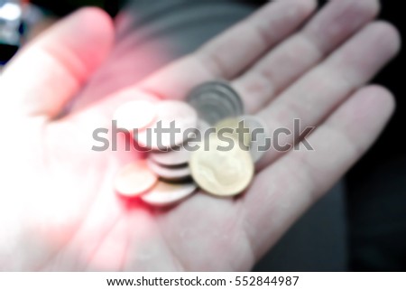 Picture blurred  for background abstract and can be illustration to article of coins in hands