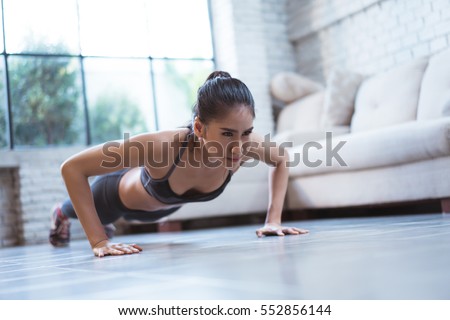 Asian women exercise indoor at home she is acted "push up" Royalty-Free Stock Photo #552856144
