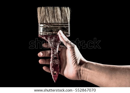 man hand holding paint brush old isolated over black background