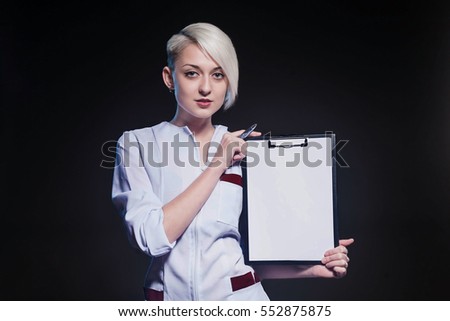  young girl with short hair in a medical lab coat with a clipboard in his hands