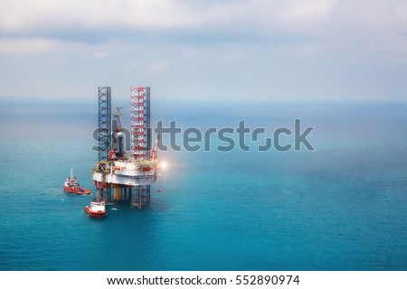 Offshore oil rig platform in the gulf  from aerial view. Royalty-Free Stock Photo #552890974