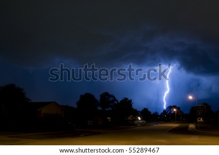 Lightning strike in a local neighborhood in a rain column Royalty-Free Stock Photo #55289467