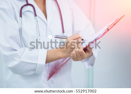 Close up of patient and woman doctor taking notes. Woman doctor concept in hospital.  Royalty-Free Stock Photo #552917002