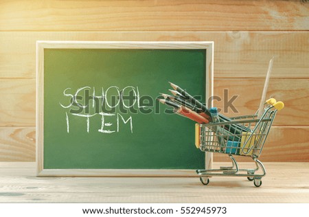 School item text display on chalkboard with shopping cart