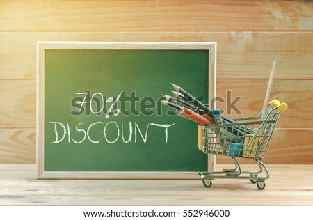 70 percent discount text display on chalkboard with shopping cart