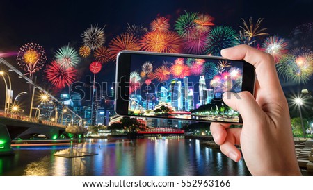 Smart phones Record Video Colorful Fireworks and Building Cityscape Skyscrapers at Night Festival, Singapore