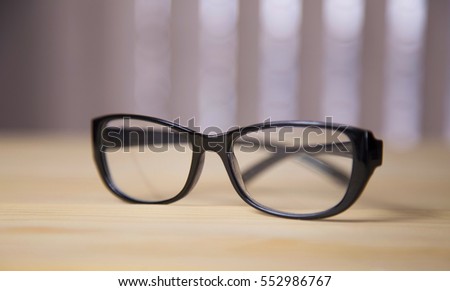 eyeglasses on wood background
