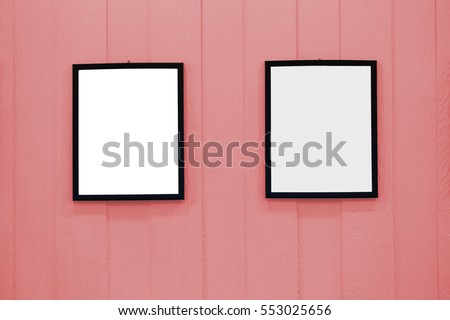 White wood picture frame on the wall pastels. Frame a blank white on the wall wooden pastel.