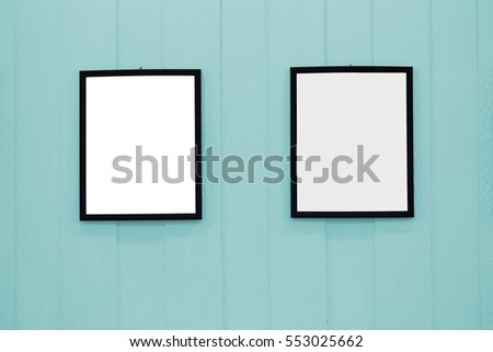 White wood picture frame on the wall pastels. Frame a blank white on the wall wooden pastel.