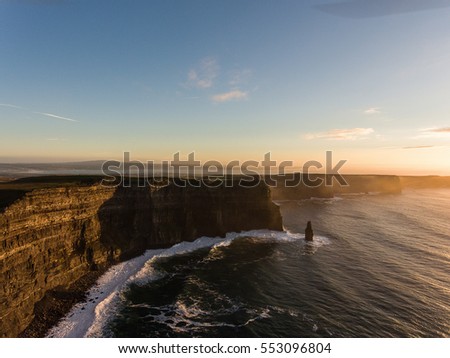 Aerial Ireland countryside tourist attraction in County Clare. The Cliffs of Moher sunset and castle Ireland. Epic Irish Landscape along the wild atlantic way. Beautiful scenic irish nature.
