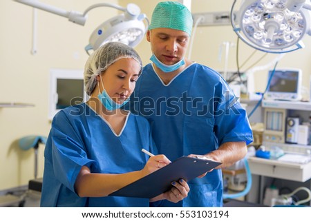 Doctor and nurse going through the paperwork