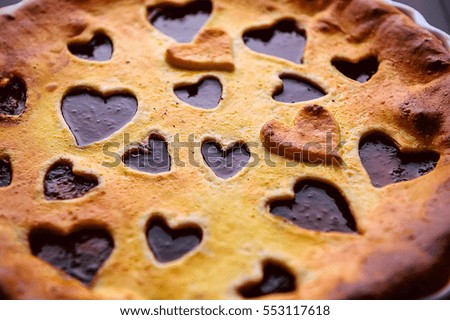 strawberry cake for Valentine's Day with hearts on a wooden background