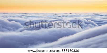 Beautiful sunset above clouds from airplane perspective. High resolution image Royalty-Free Stock Photo #553130836