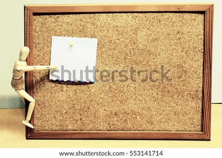 Wooden Figure Doll with Blank Cork Board. Image is Retro Filtered.