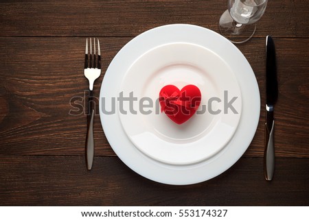 Festive table setting for Valentines day on rustic wooden table. Top view, copy space