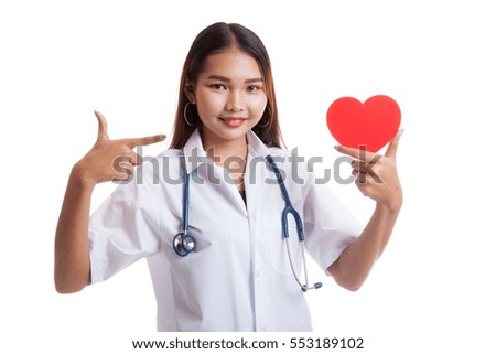 Young Asian female doctor point to red heart  isolated on white background.