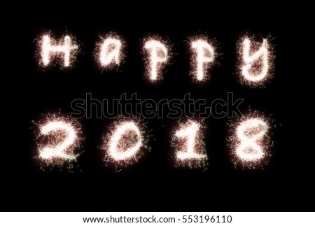Happy 2017. The words are written with fireworks sparklers on black background